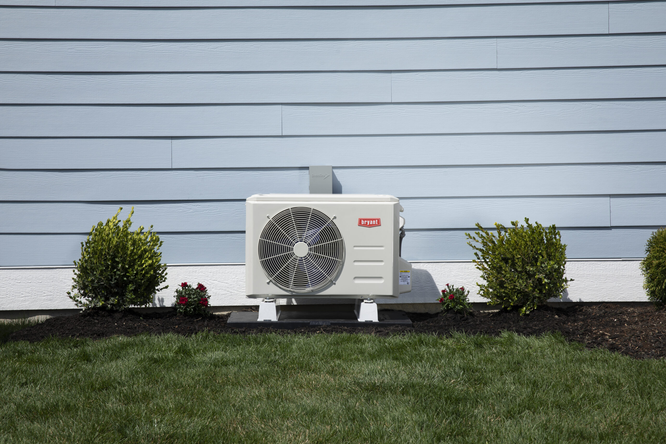 Heat pump outside of a blue home