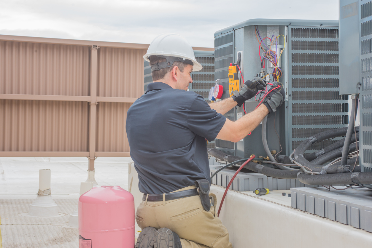 Man repairing an air conditioning unit