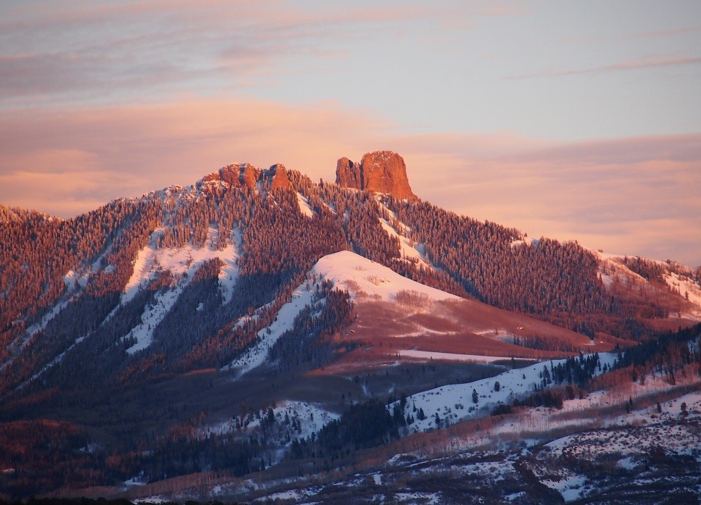 mountina in castle rock co, red tint with snow on the mountains