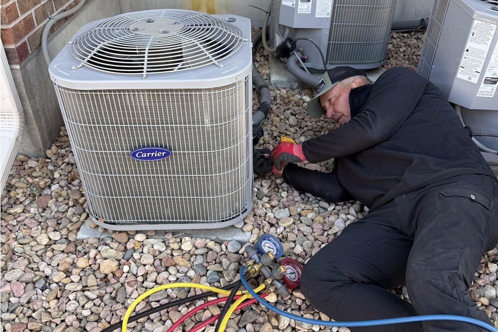 Technician repairing an air conditioing unit