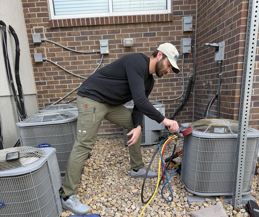 Man checking refrigerant on an air conditioner in Parker CO
