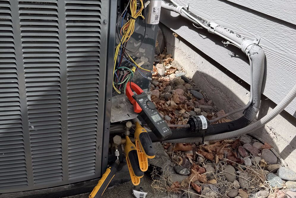 tools checking an ac unit
