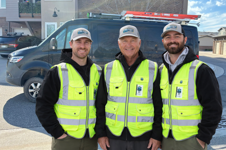 HVAC technicians standing in front of a van