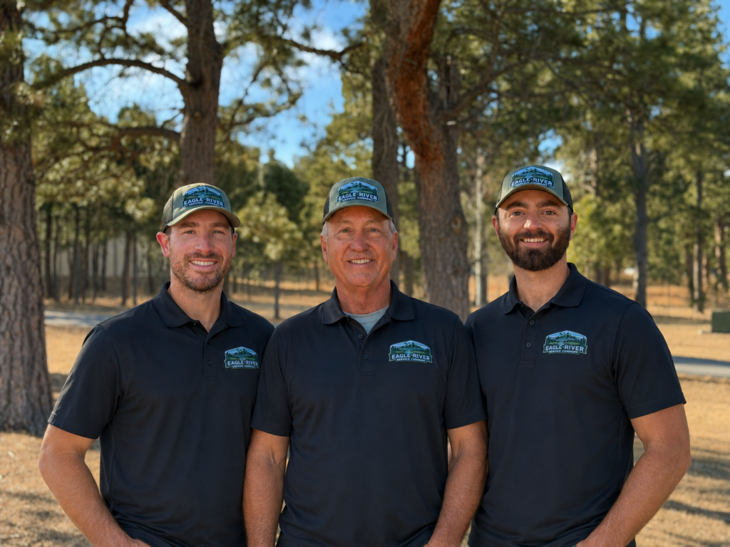 Three men standing together wearing Eagle River Service shirts.