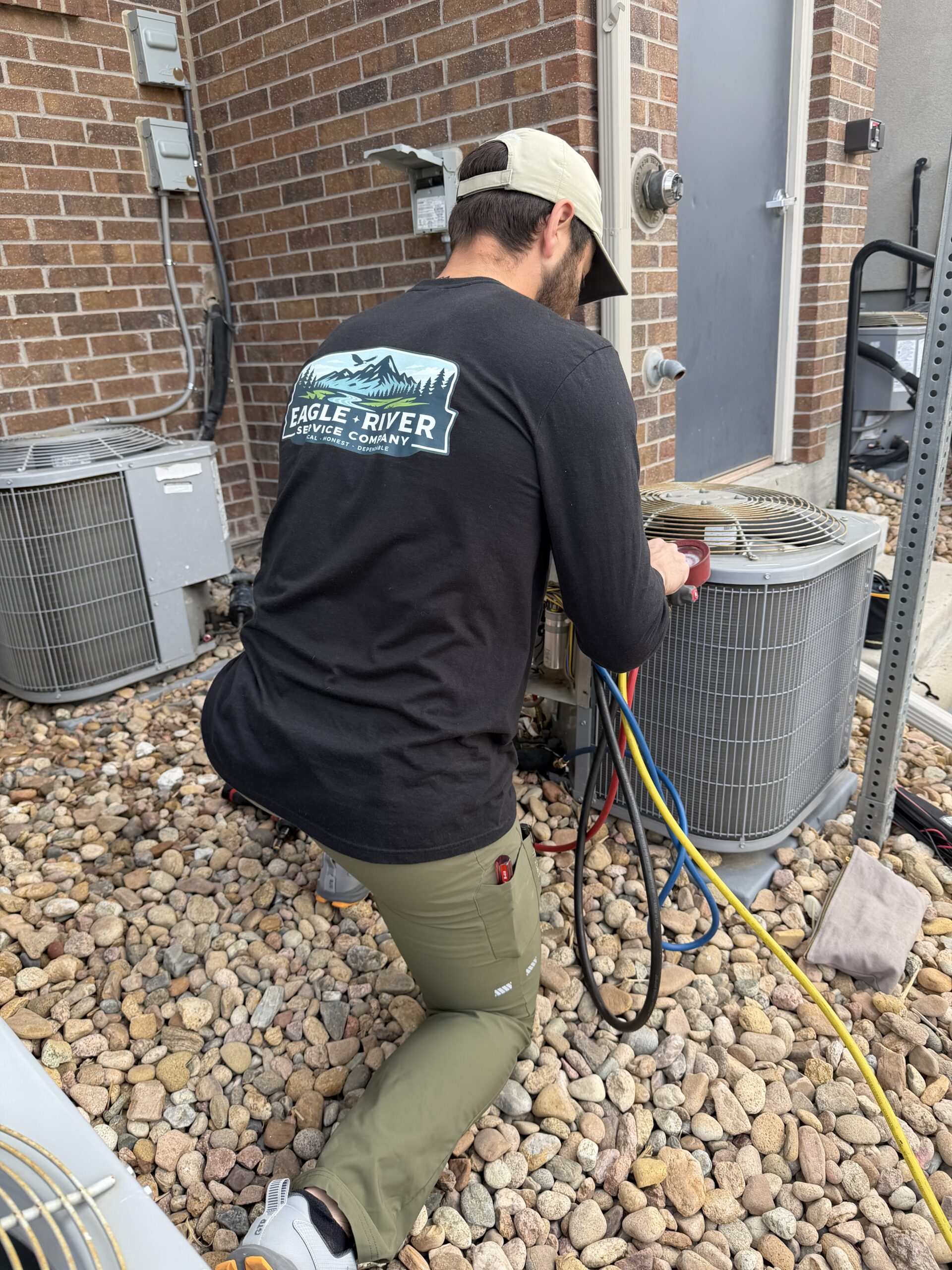 hvac technician repairing an air conditioner