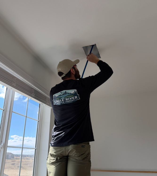 Man cleaing an air duct in monument colorado