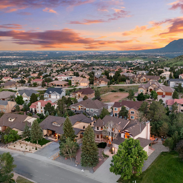 upscale homes in monument colorado with sunset in the background