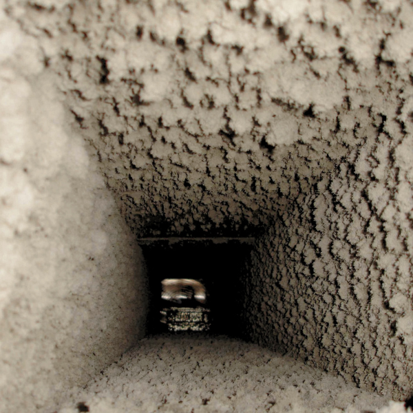 image of dust caked inside an air duct in a home