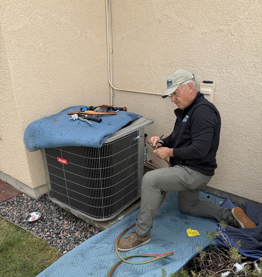 man installing an air conditioner in monument co
