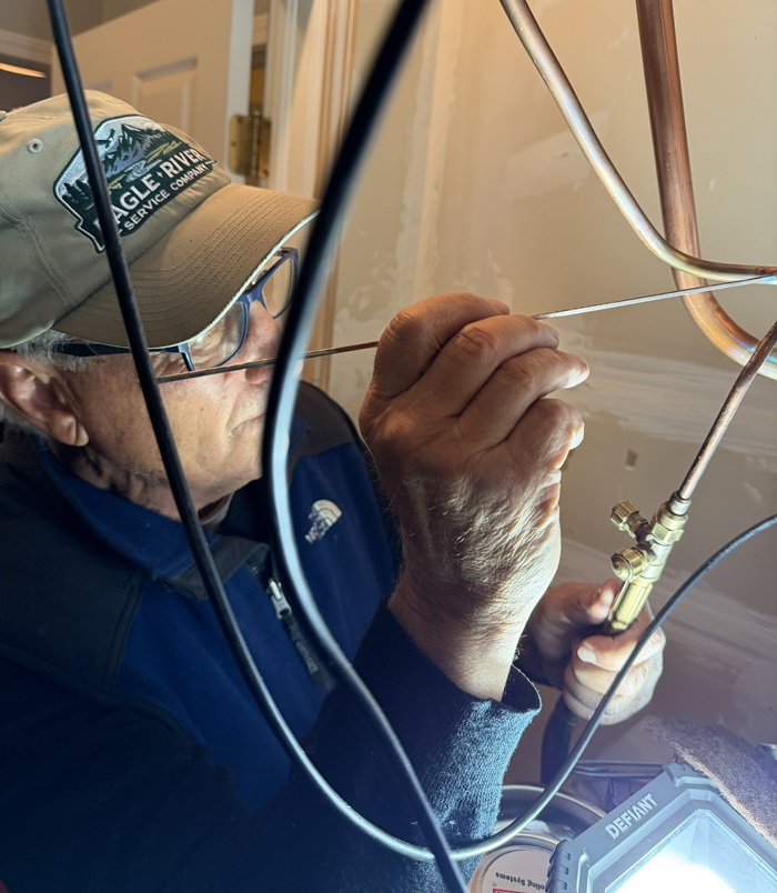 man welding and repairing a furnace