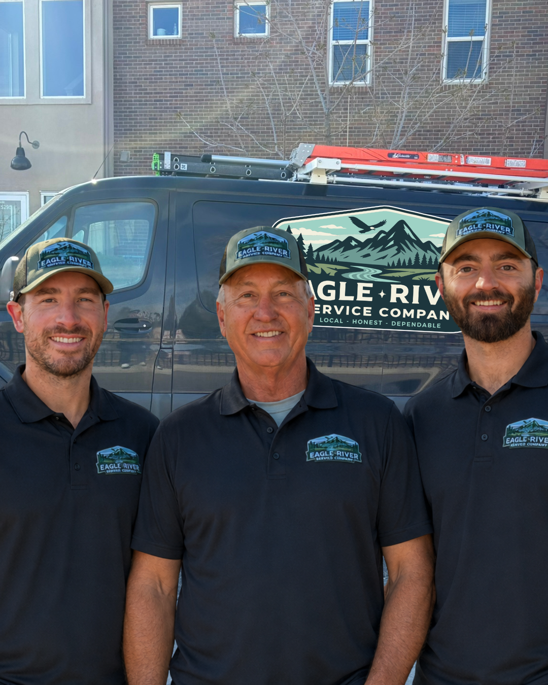 Three HVAC techicians in front of a service van